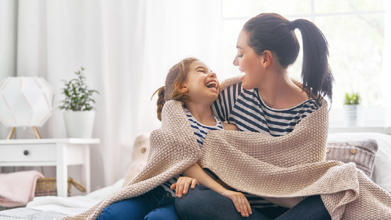 Mother and daughter laughing together