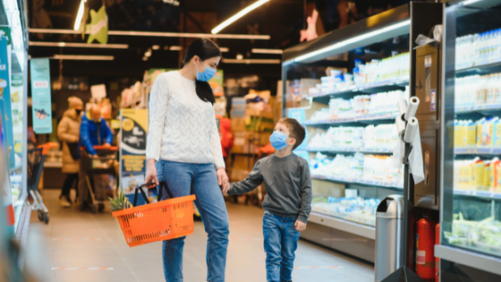 Mother and son grocery shopping together.