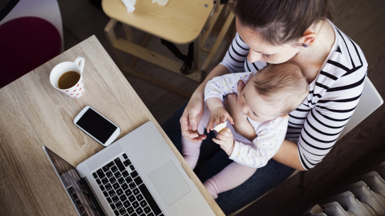 Mother working with baby in her lap