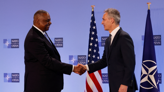 NATO Secretary-General Jens Stoltenberg and U.S. Defence Secretary Lloyd Austin shake hands on the day of a NATO Defense Ministers meeting in Brussels