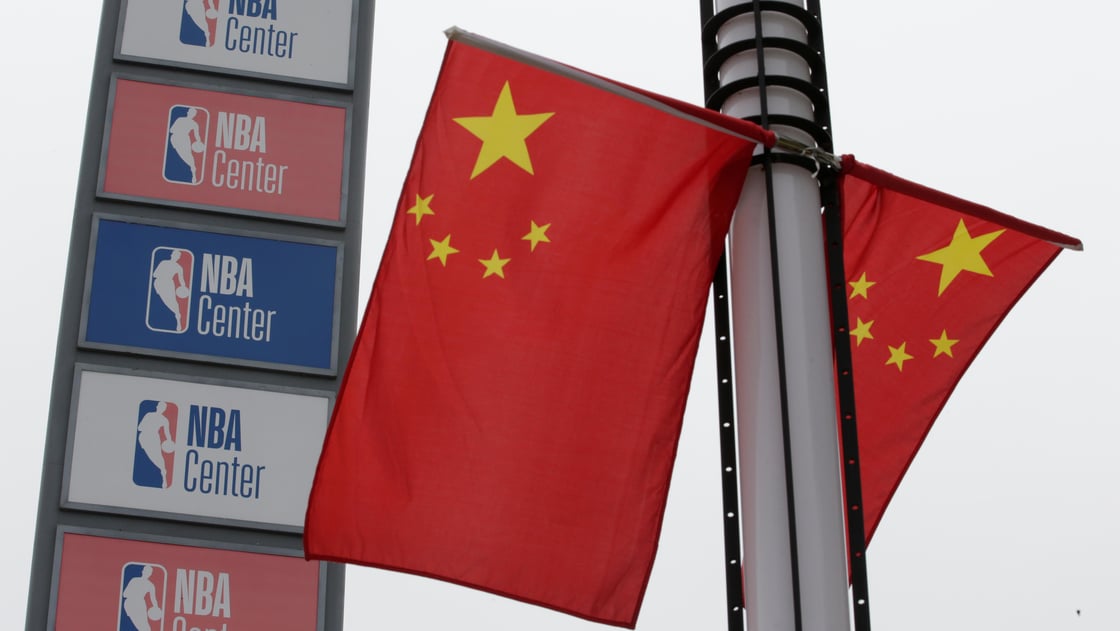 NBA logos are seen next to Chinese national flags