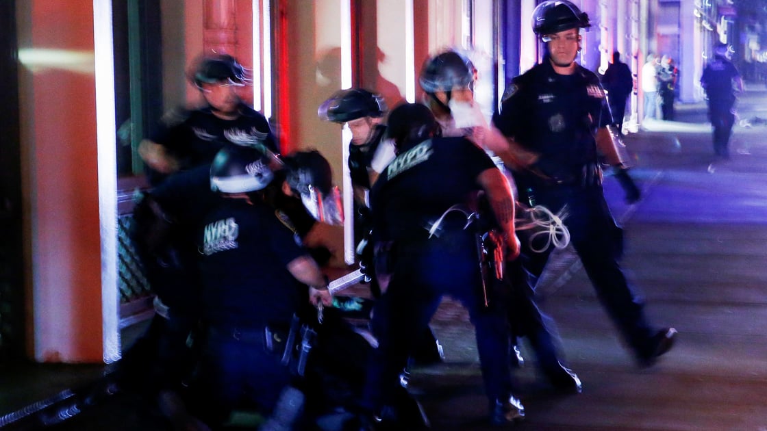 NYPD officers detain a protester who was looting in a store after marching against the death in Minneapolis police custody of George Floyd in the Manhattan borough of New York City