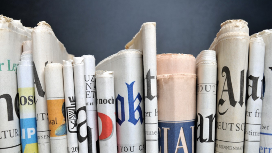 Newspapers arranged on a shelf