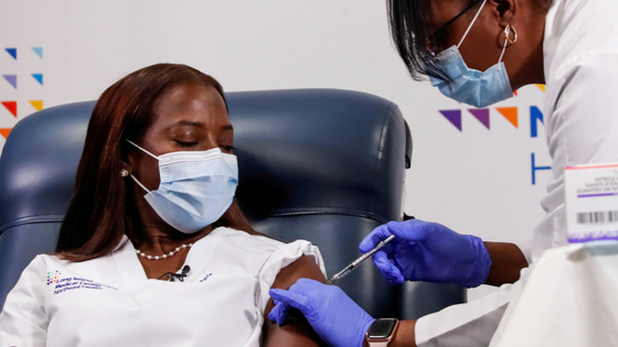 Nurse recieves the second dose of a Pfizer covid vaccine