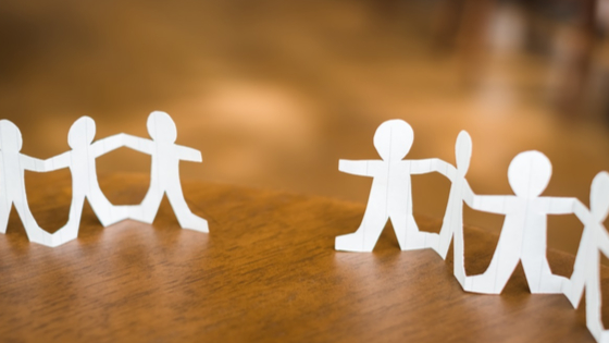 Paper cutouts of people on desk