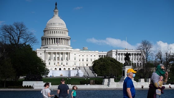 Pedestrians and visitors spend time outdoors near the U.S Capitol amid the Coronavirus pandemic.