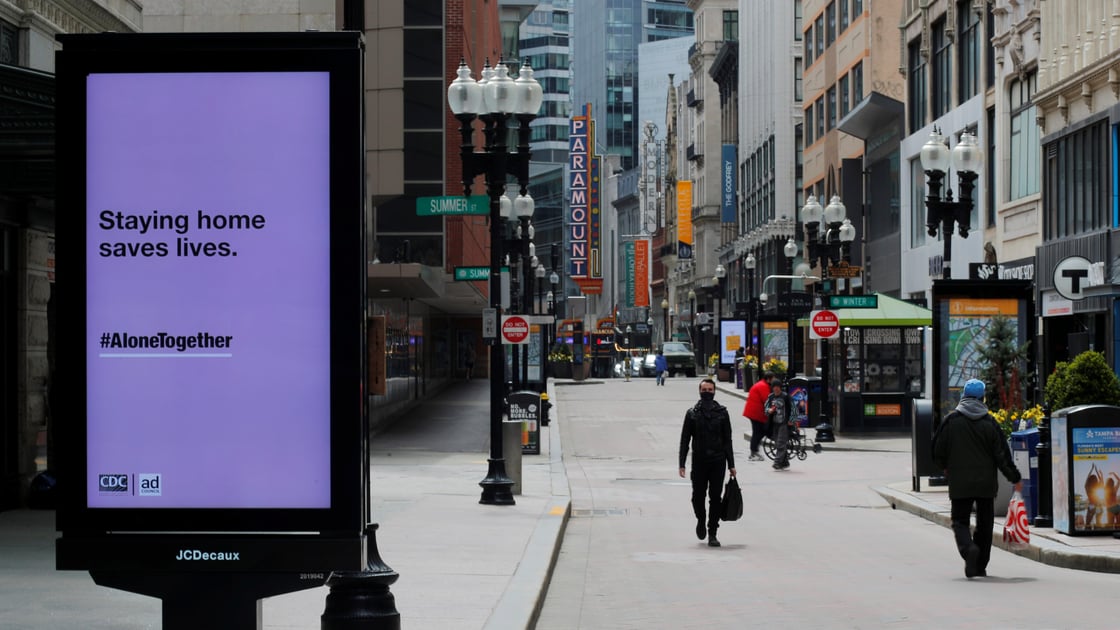 Pedestrians walk through the nearly empty Downtown Crossing shopping area after Massachusetts Governor Charlie Baker extended his stay at home advisory