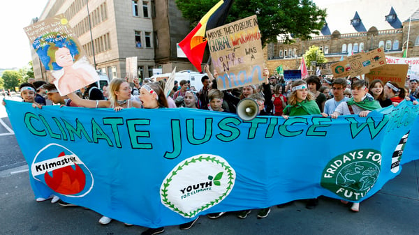 People attend a demonstration calling for action on climate change during the Fridays for Future demonstration in Aachen