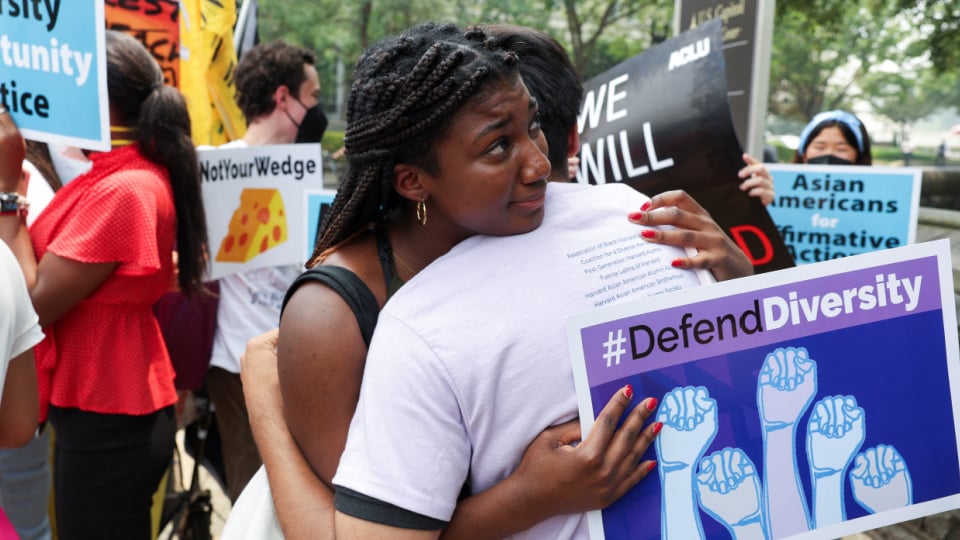 People embrace each other after the U.S. Supreme Court decision to strike down race-conscious student admissions programs at Harvard University and the University of North Carolina.