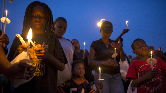 People gather for a candlelight vigil against gun violence in the Englewood neighborhood in Chicago