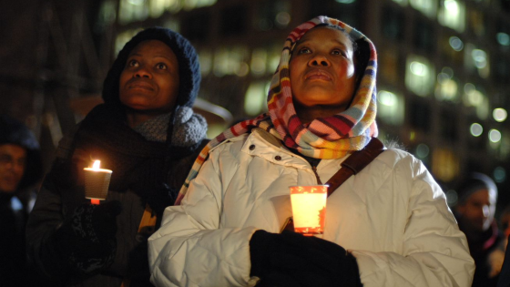 People gather for a vigil after gun violence