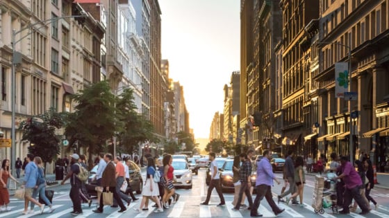 People go across a crosswalk in New York City.