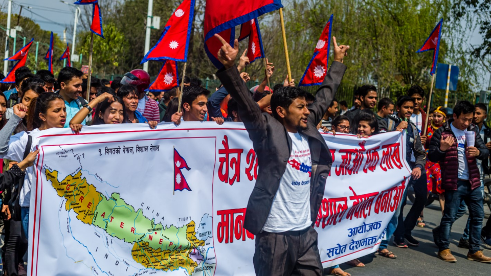 People march in Nepal with flags and posters