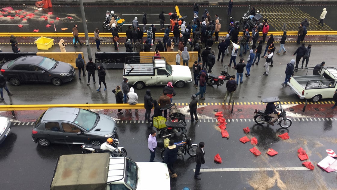 People protest against increased gas price, on a highway in Tehran