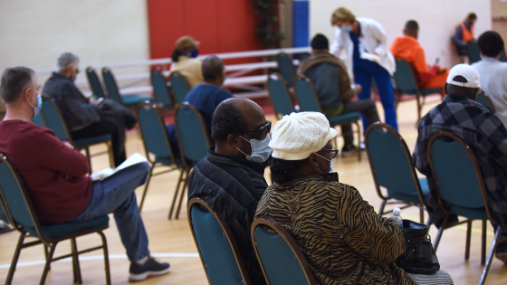 People sit in the observation area after receiving a dose of the Pfizer COVID19 vaccine at Shiloh Baptist church