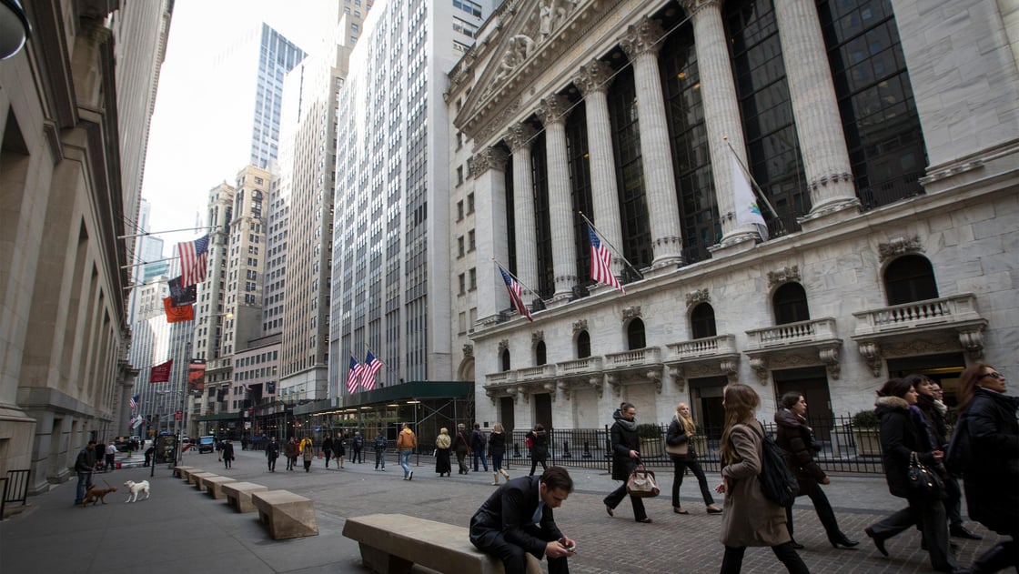 People walk by the New York Stock Exchange in New Yorks financial district