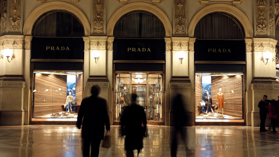 People walk past Prada fashion store in downtown Milan