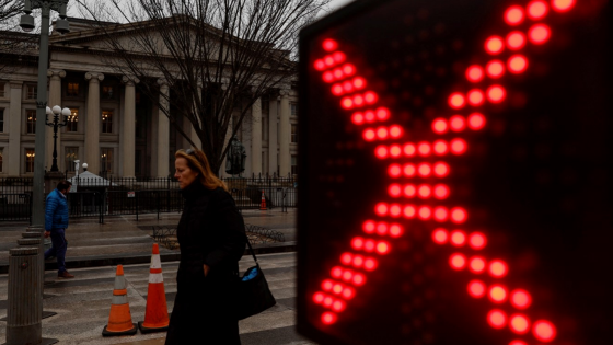 People walk past the U.S. Treasury building in Washington