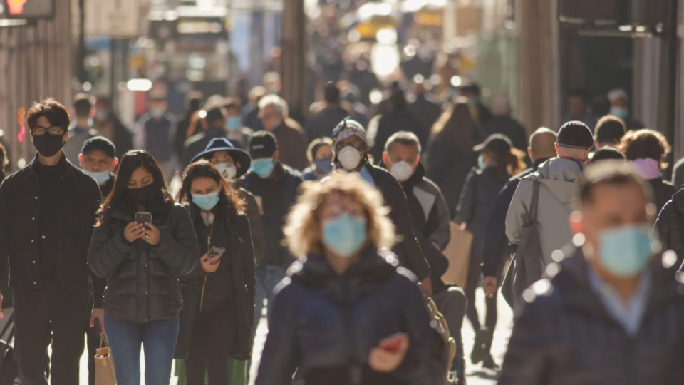 People walking while wearing masks to protect themselves from COVID19