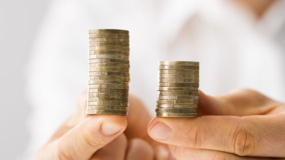 Person holding two stacks of coins