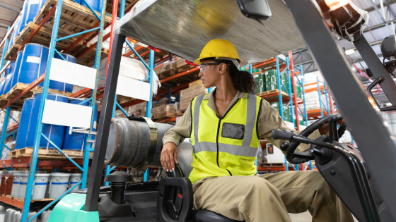 Person operating forklift in warehouse