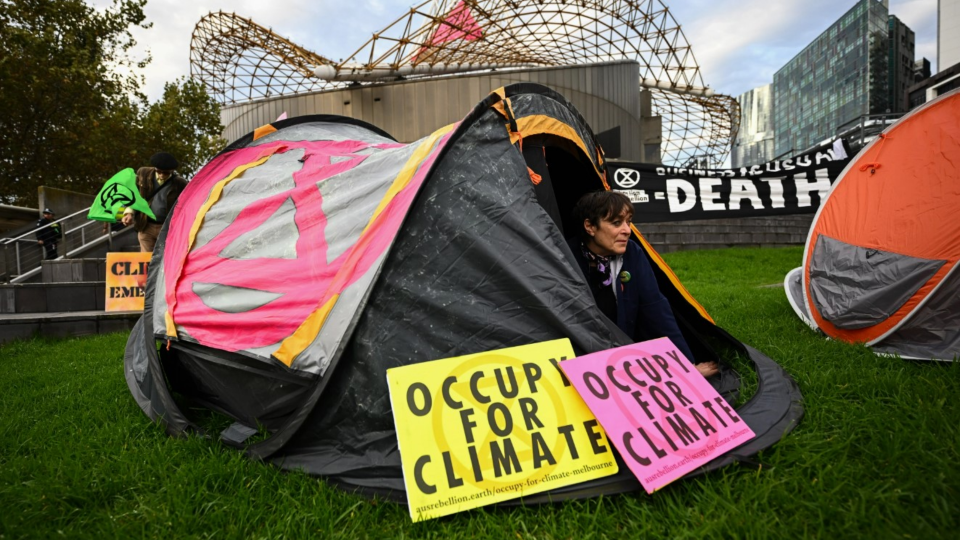 Person sitting in tent and protesting inaction on climate change