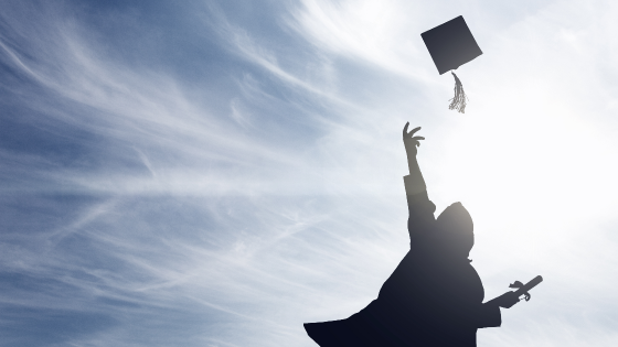 Person throwing graduation cap in the air