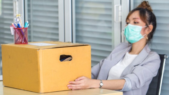 Person who lost her job sits with supplies