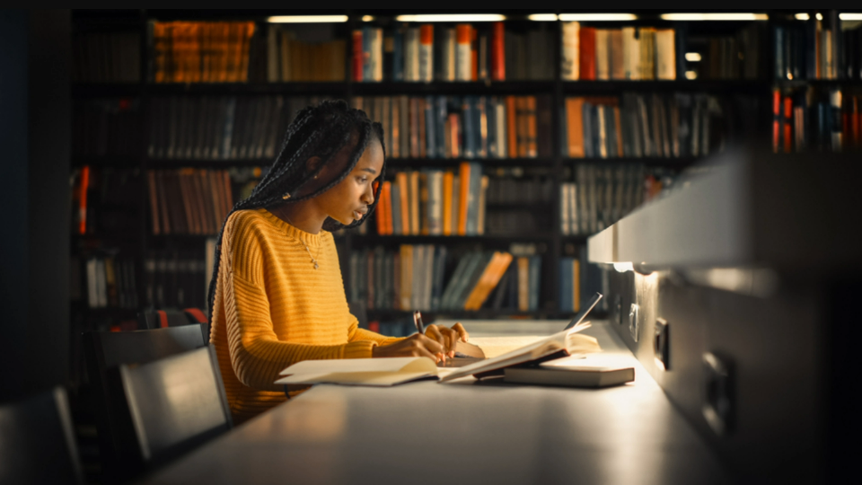 Person working on coursework in library