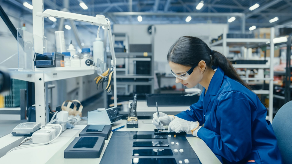 Person works on installing chip into smartphone in a lab