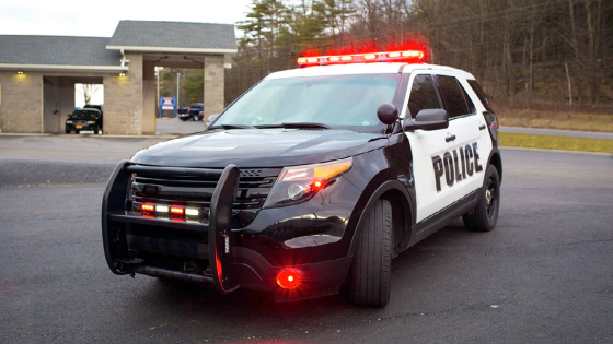 Police car with emergency lights and siren on street