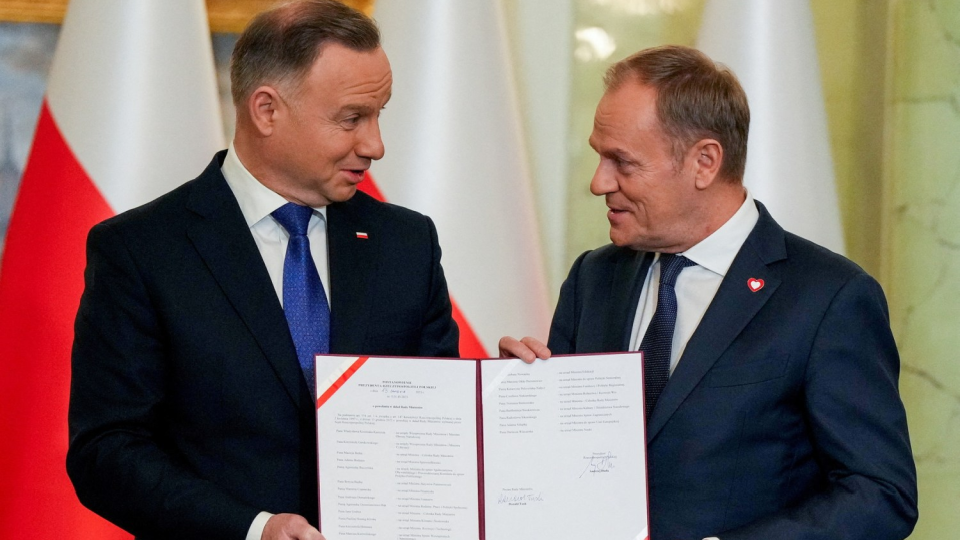 Polish President Andrzej Duda and newly appointed Polish Prime Minister Donald Tusk attend the cabinet swearing-in ceremony 