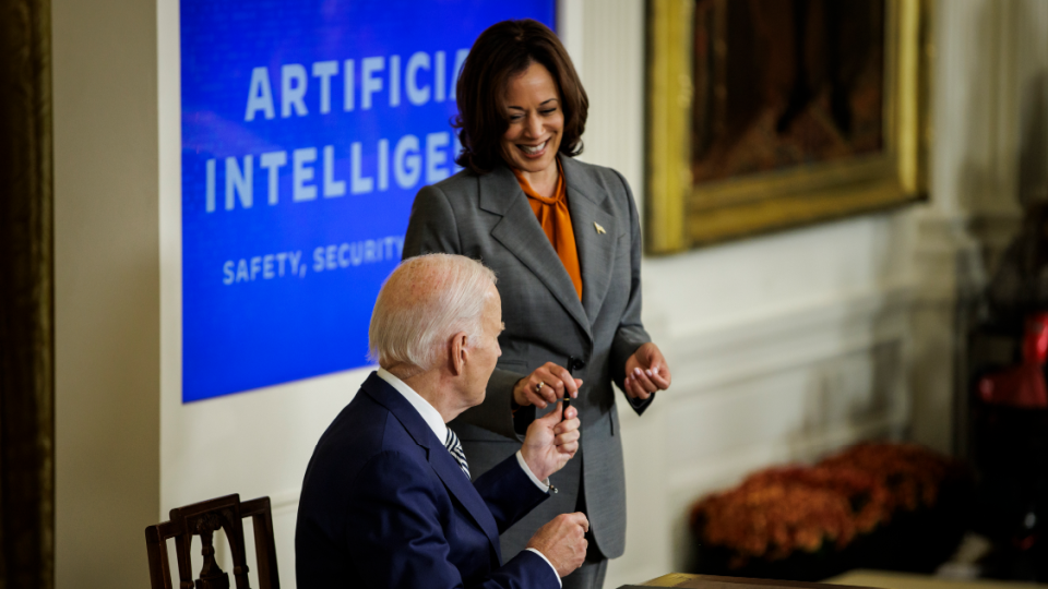 President Joe Biden hands his pen to Vice President Kamala Harris after signing an executive order on Artificial Intelligence in the East Room at the White House on October 30, 2023