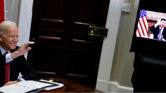 President Joe Biden waves to Chinese leader Xi Jinping as they begin a virtual meeting