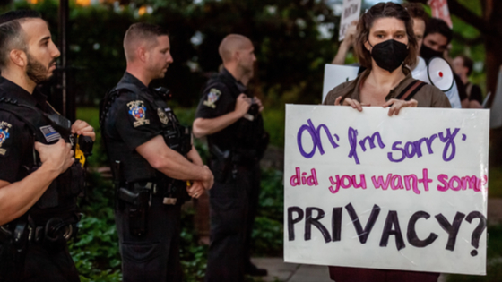 Pro-choice protestors march past police officers in front of Justice Brett Kavanaugh’s house. 