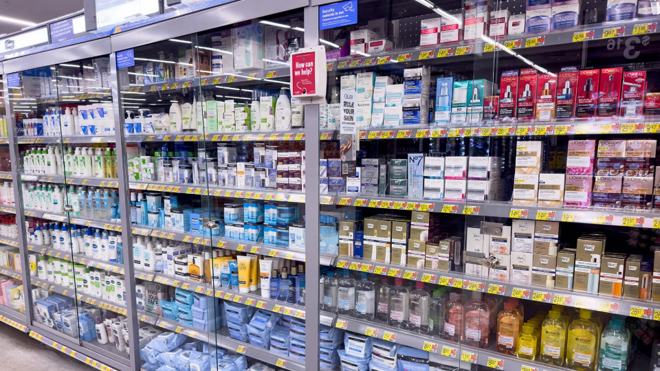 Products seen behind protective glass barriers in drugstore