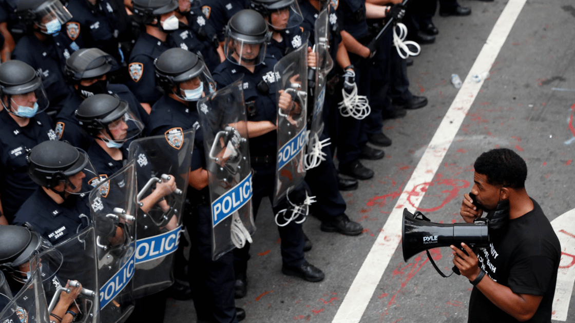 Protester in front of police officers