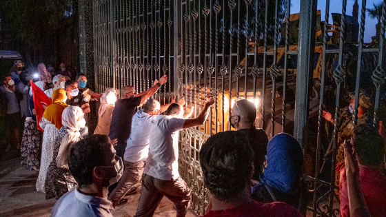 Protesters at the closed gate of the Tunisian parliament