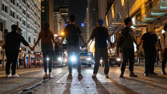 Protesters link hands and stop traffic