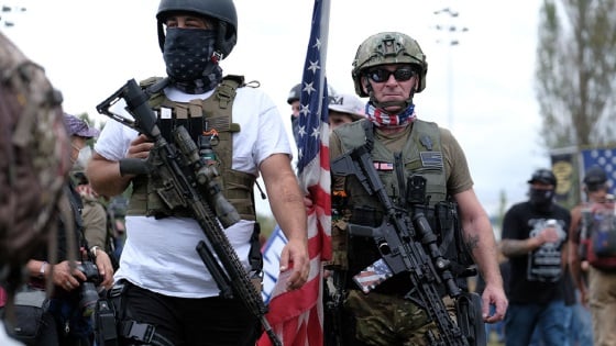 Proud Boys carry assault rifles as they gather in Portland