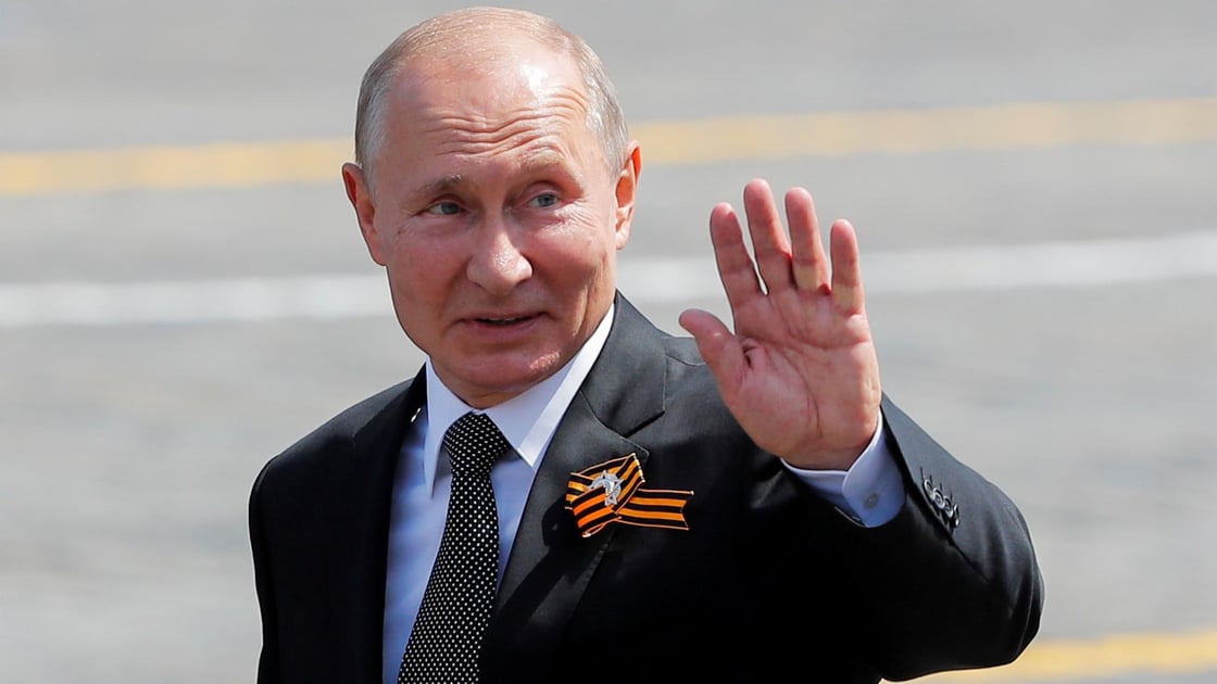 Putin waves as he leaves after the Victory Day Parade in Red Square in Moscow