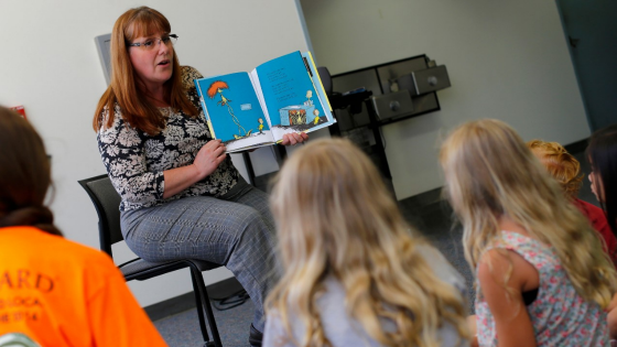 Reference librarian Marlayna Christensen reads to children