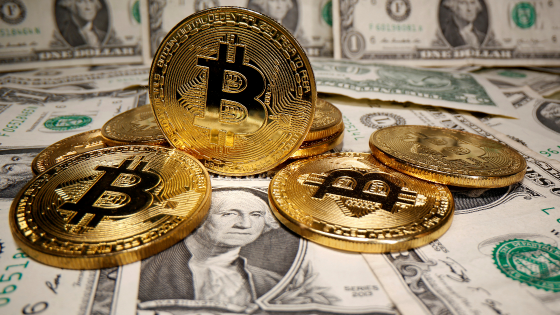 Representations of virtual currency Bitcoin are placed on U.S. dollar banknotes