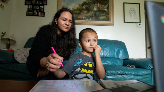Rosario Correa, 34, and her son Michael Gamino Correa, 5, participate in his school Zoom class at home