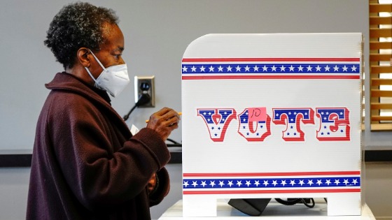 Ruby Lenora casts her in-person vote on her 73rd birthday at a polling site at the Milwaukee Public Library