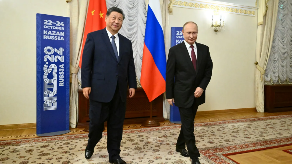 Russian President Vladimir Putin and Chinese President Xi Jinping walk during a meeting on the sidelines of the BRICS Summit in Kazan, Russia