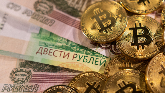 Russian ruble banknotes and representations of the cryptocurrency Bitcoin are seen in this illustration