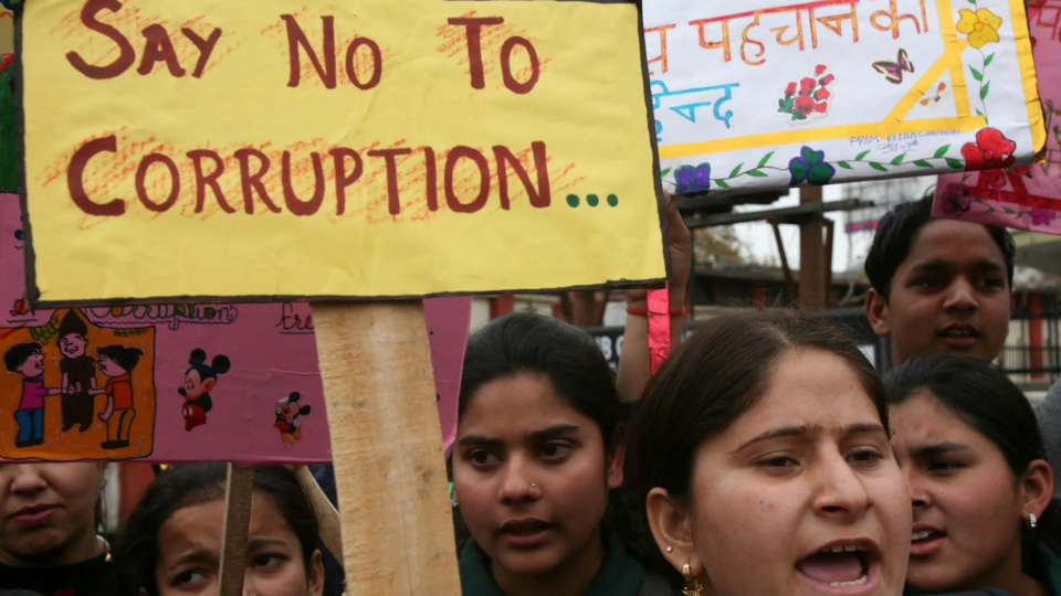 School students shouted slogans during a protest against a corruption case in Jammu