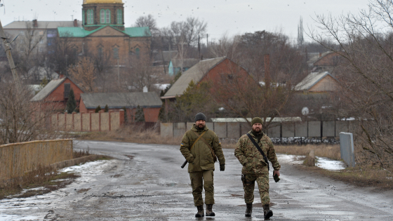 Service members of the Ukrainian armed forces walk at combat positions in Donetsk region as tensions rise