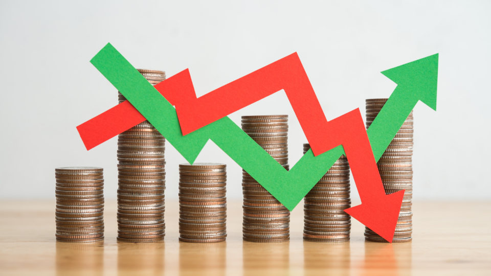 Set of coins with going up and going down representation to indicate growth and loss